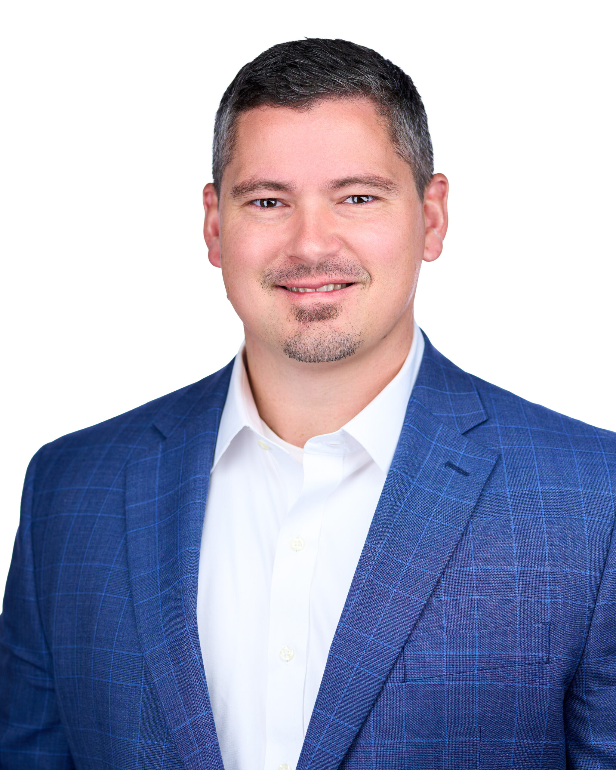 Headshot of Navigate partner Brad Clark wearing blue suit jacket and white button down shirt